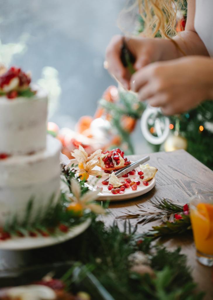 Woman decorating what appears to be a wedding cake for photos