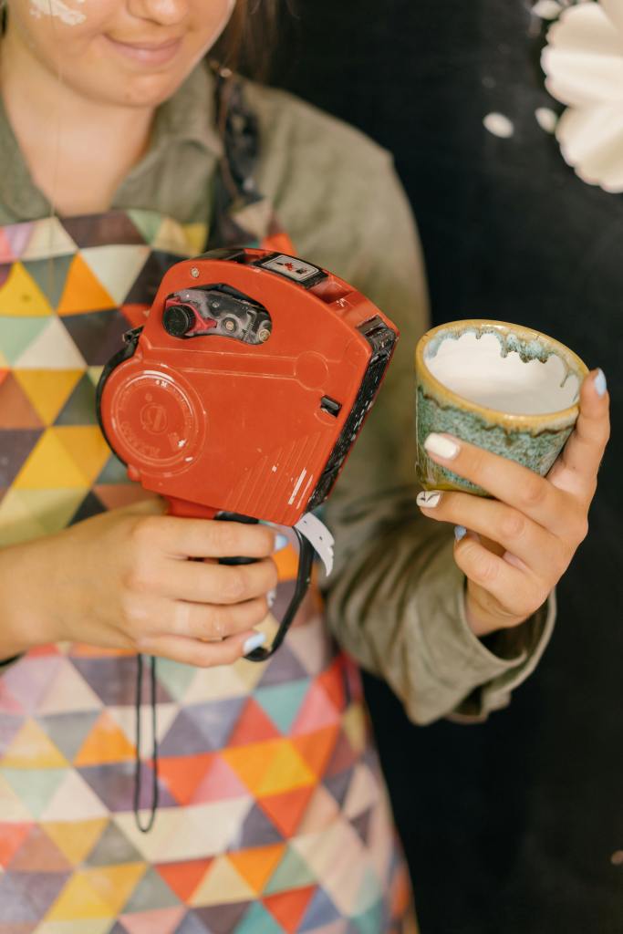 women pricing a ceramic cup