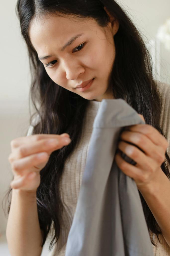 a woman inspecting clothes