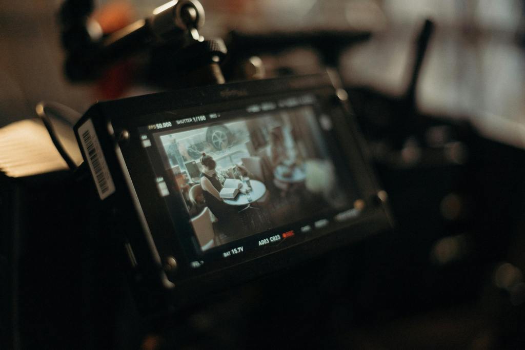a camera recording a women reading in a cafe