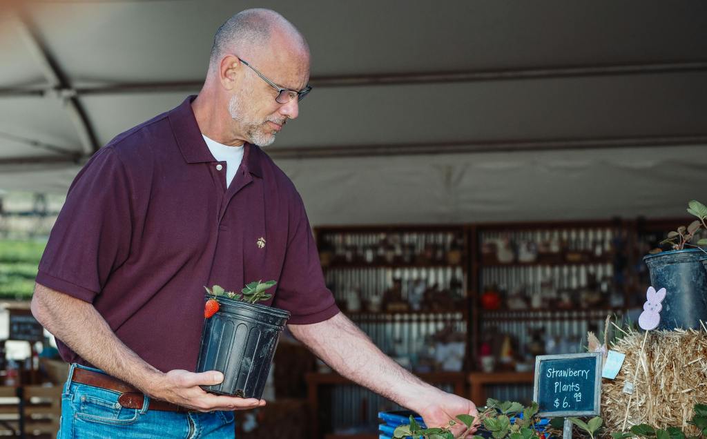Garden shop owner organizing plants
