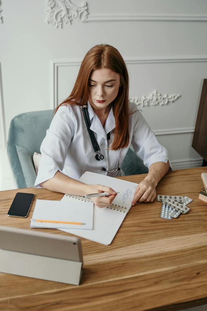 female doctor writing on a notebook