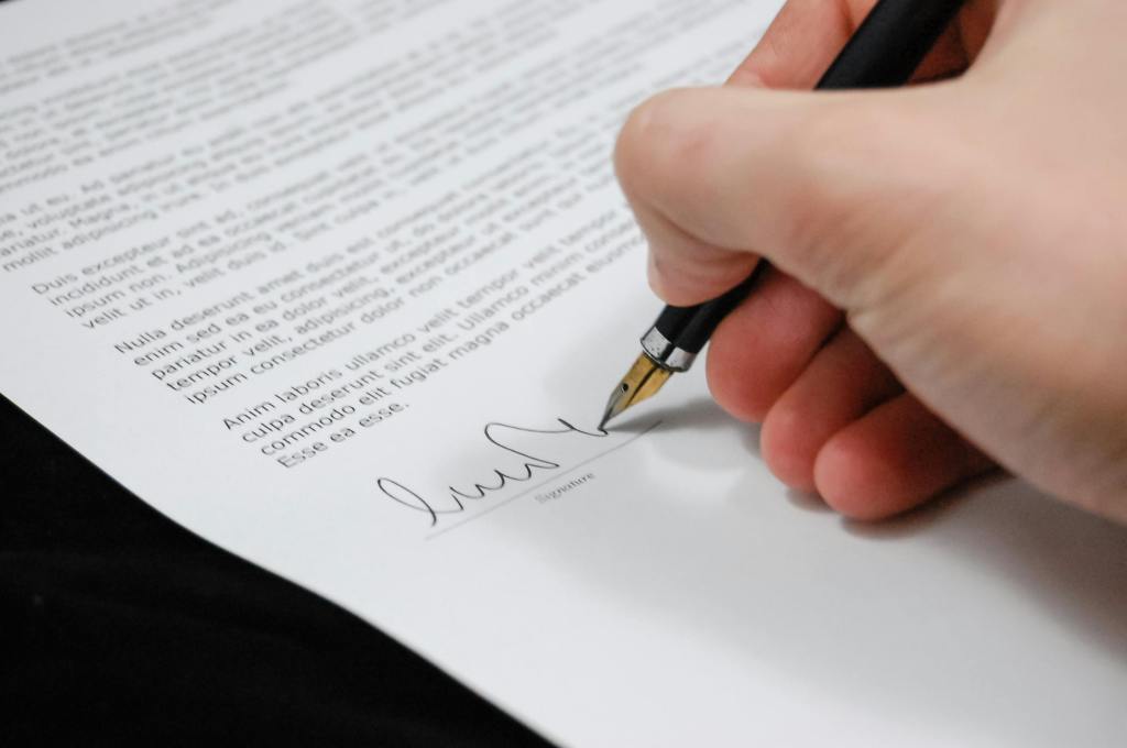 Hand signing on a paper or contract