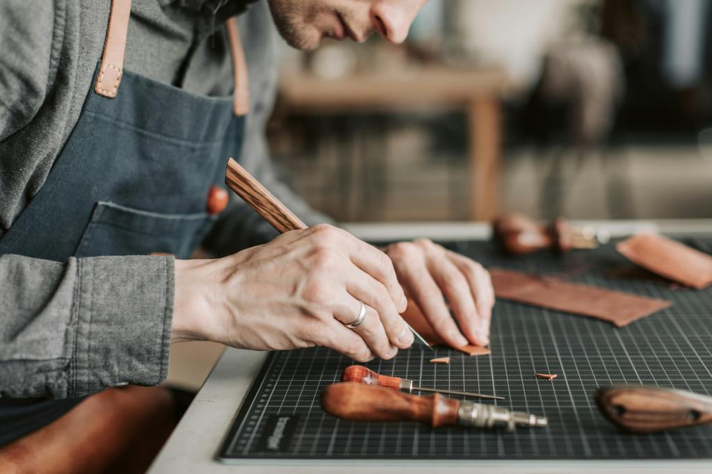 Leatherworker cutting a piece of leather