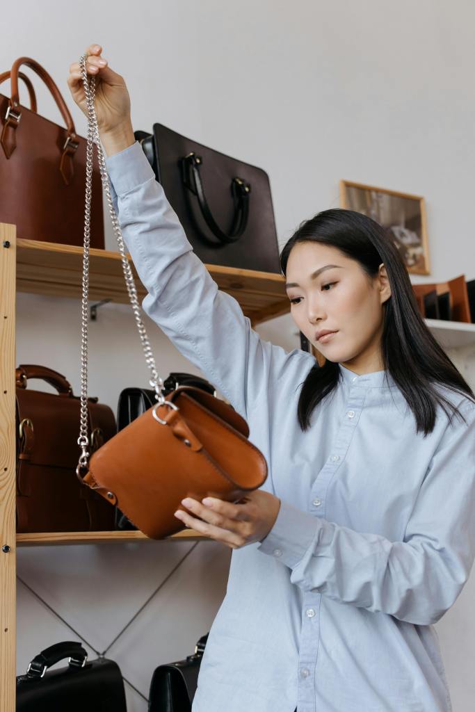 Woman holding a leather purse in a retail environment
