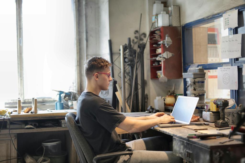 A student sitting at his desk at home in front of a laptop