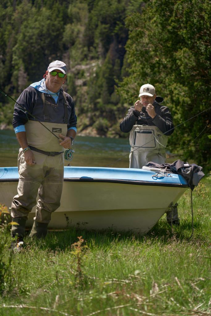 2 men prepare gear to go fly fishing