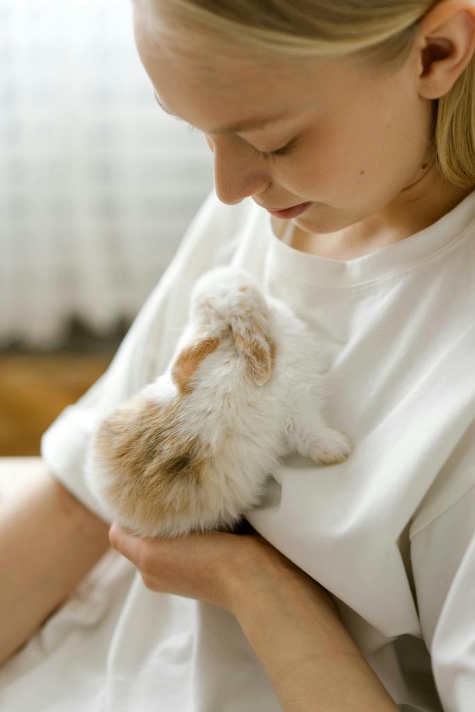 Girl hugging a small rabbit