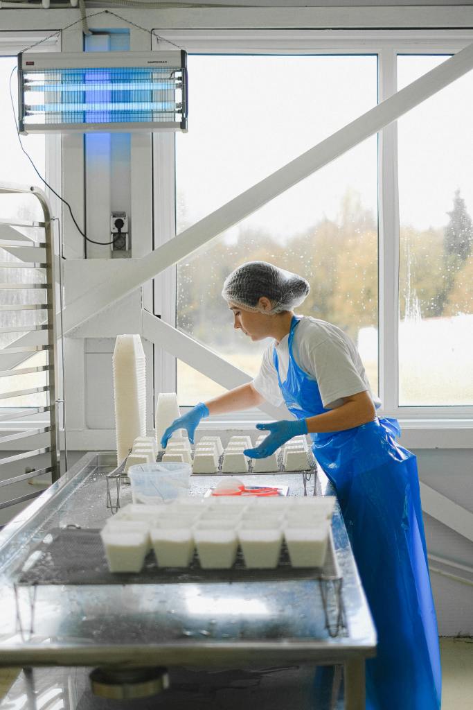 Employee at a rabbit processing plant organizing containers