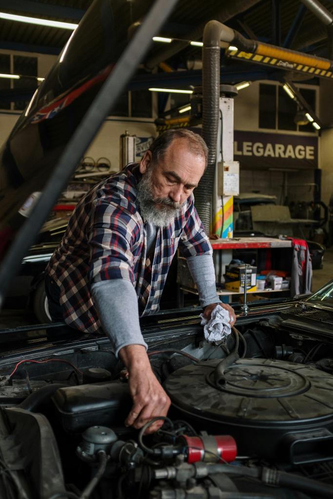 a man repairing an engine in a repair shop