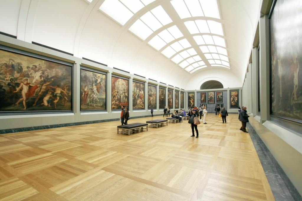People inside of a large art museum with skylights overhead