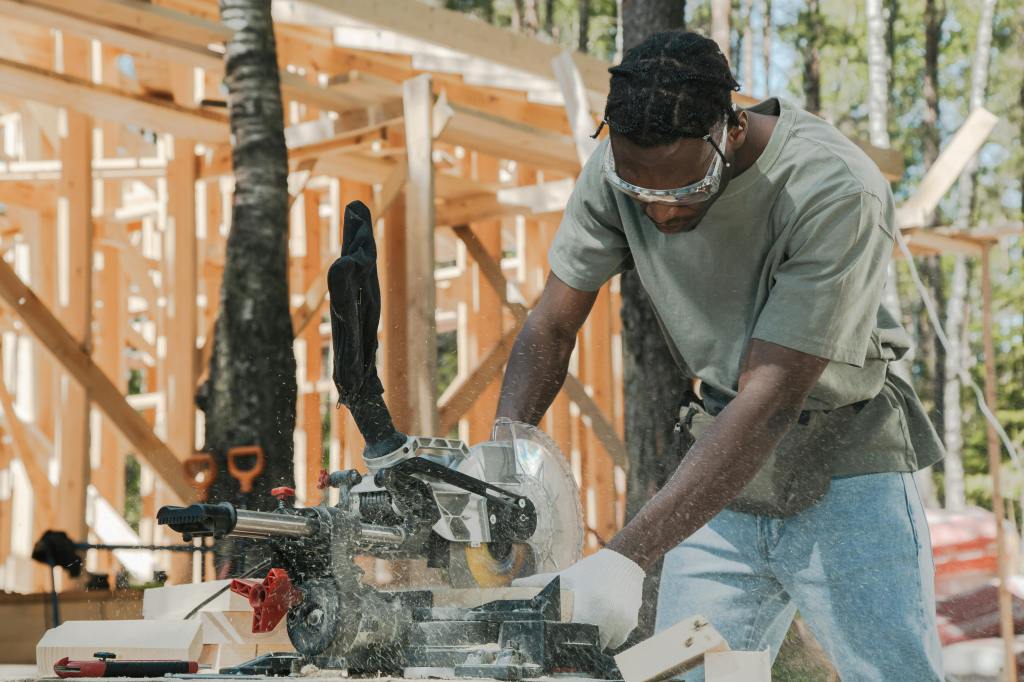 carpenter cutting wood using circular saw at what appears to be a homebuilding construction site